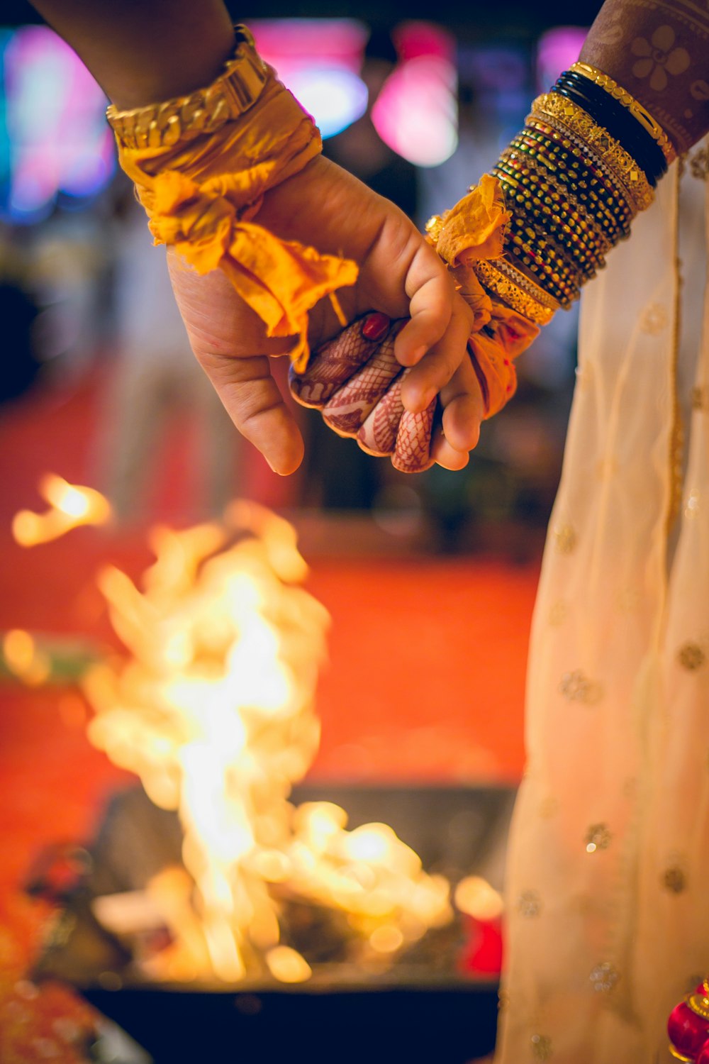 a close up of two people holding hands