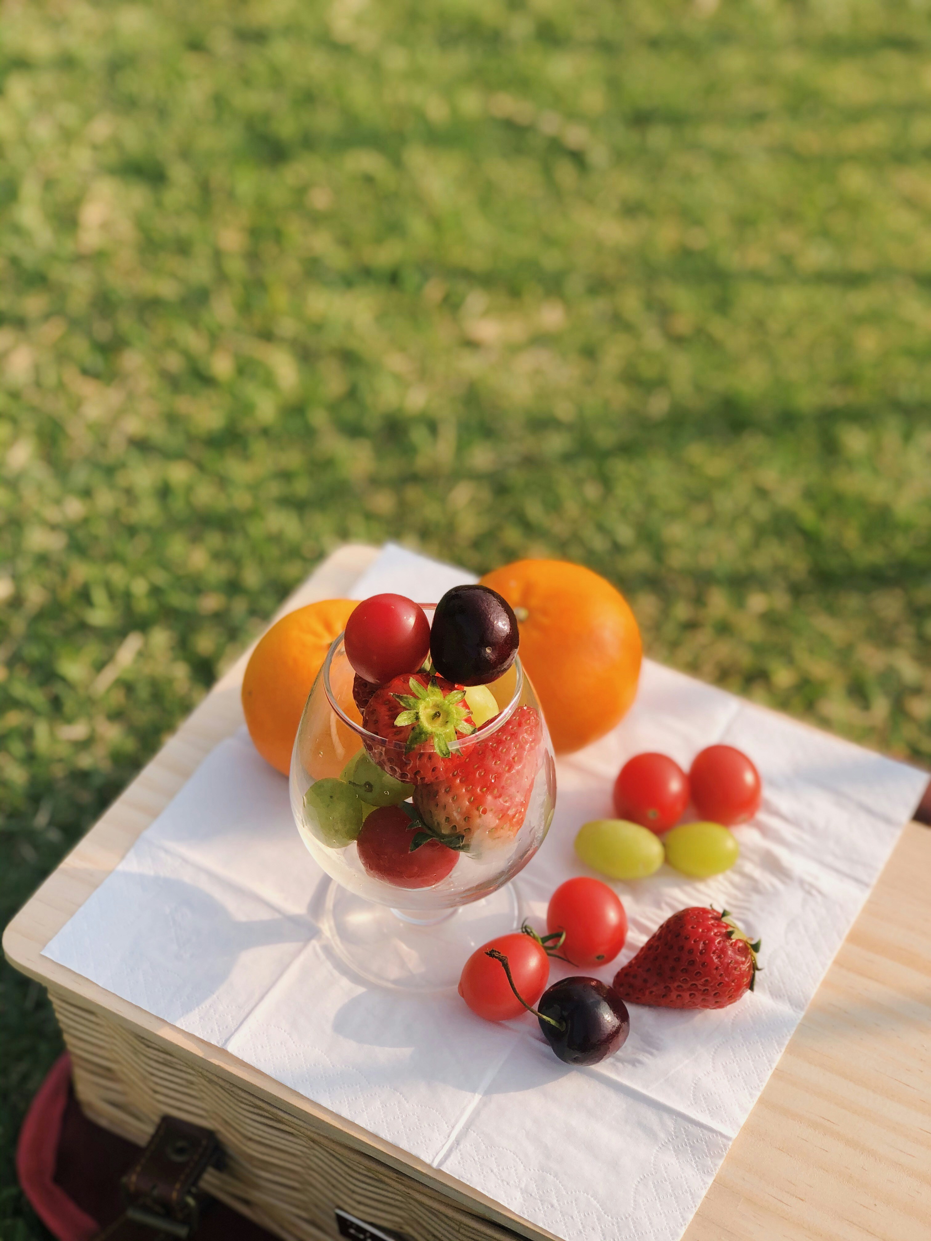 a table topped with a bowl of fruit on top of a table