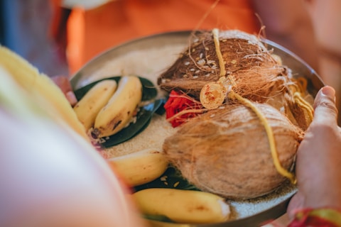 a person holding a plate of food with bananas