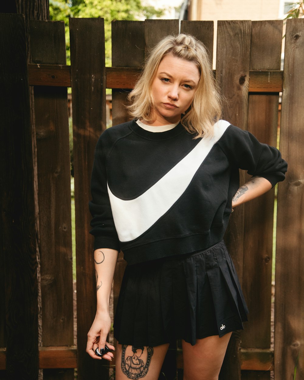 a woman in a black and white sweater and skirt