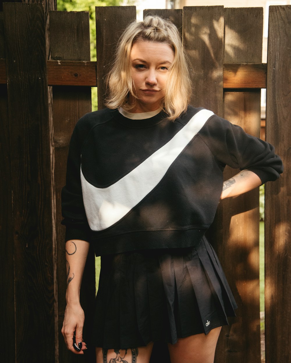 a woman in a black and white sweater and skirt