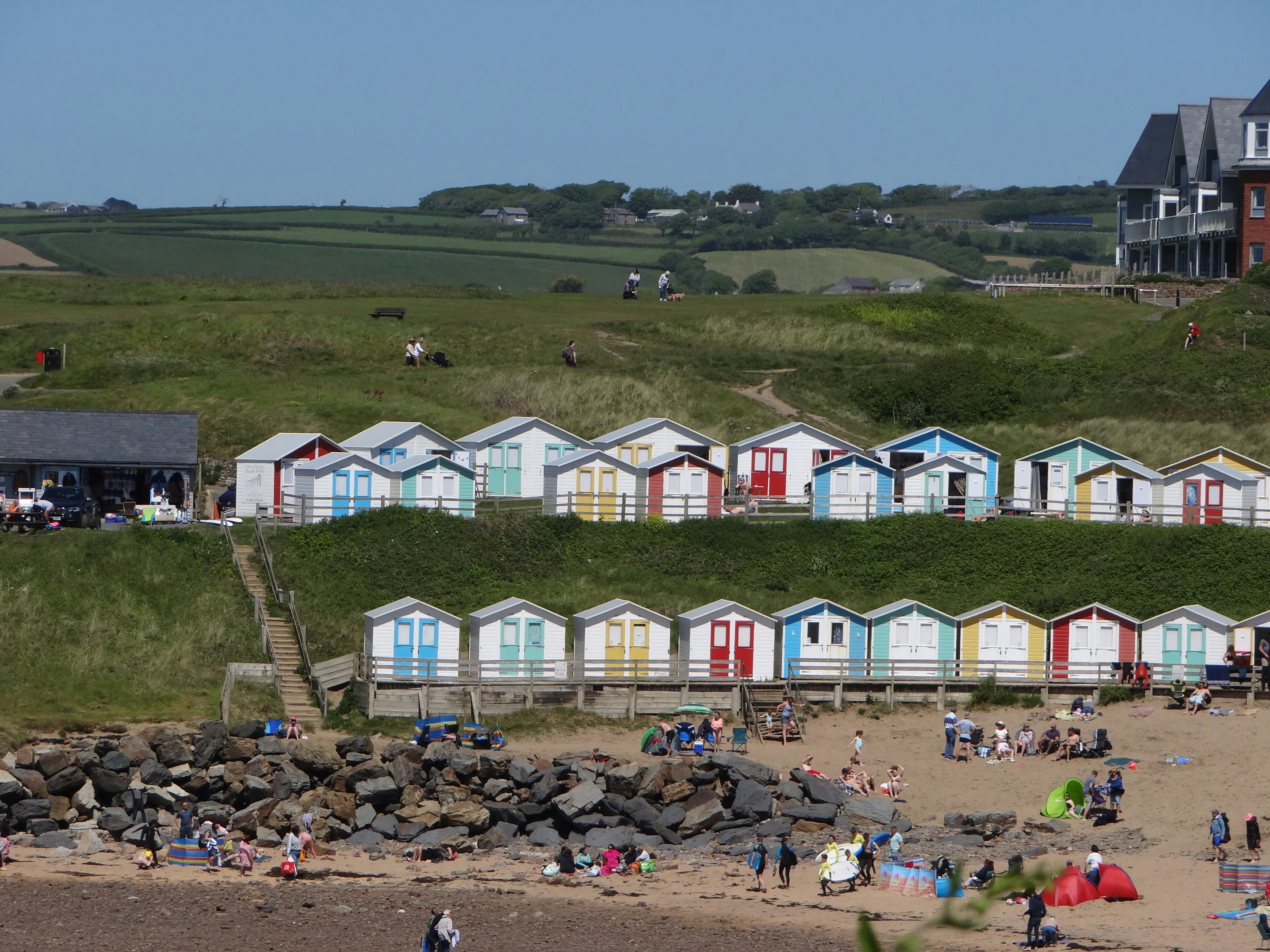 a group of people standing on top of a sandy beach