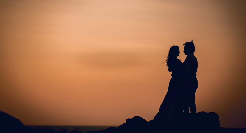a silhouette of a man and a woman holding each other