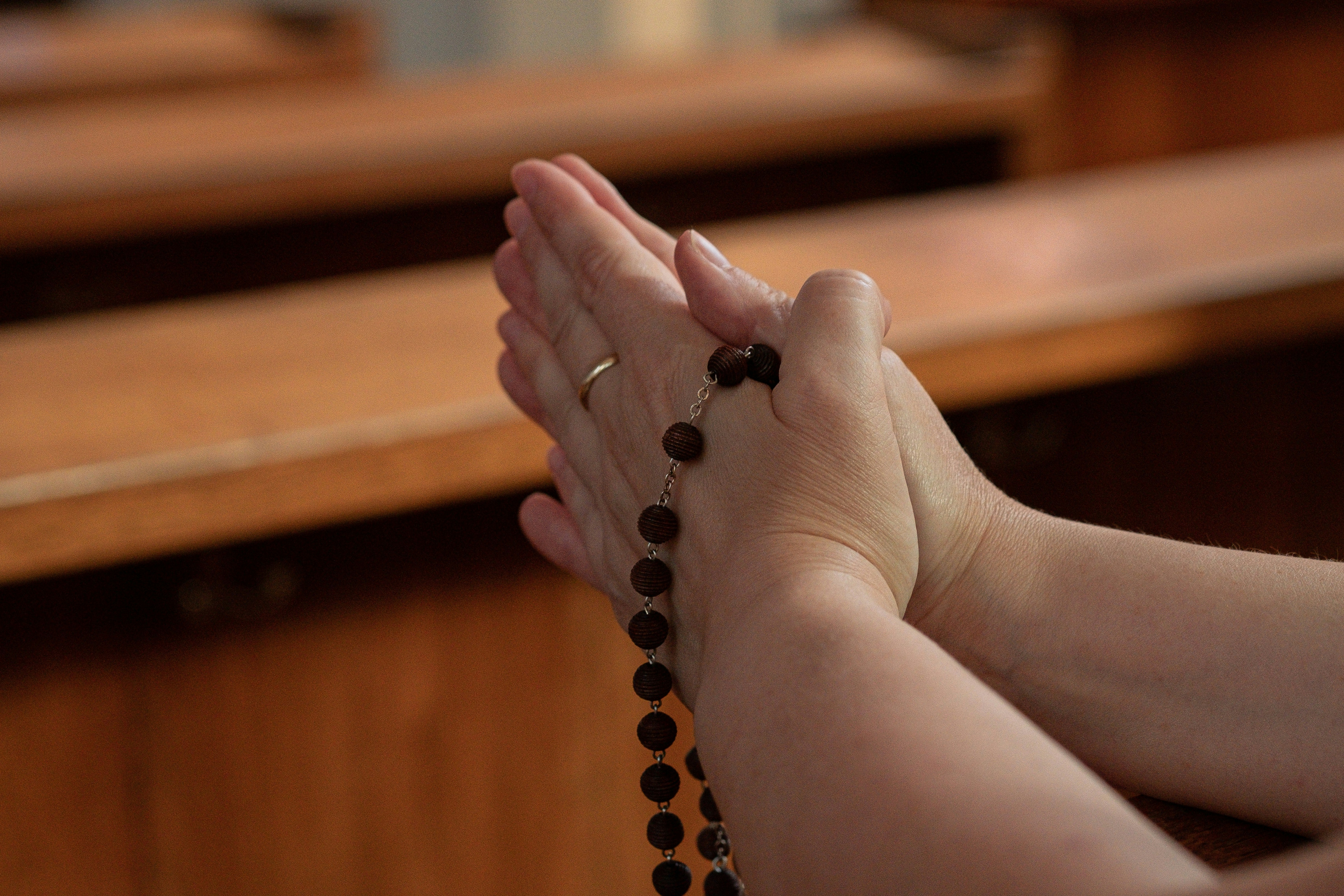 Woman praying with beads