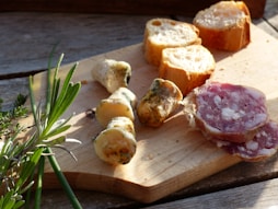 a wooden cutting board topped with different types of food