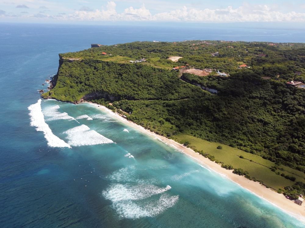 an aerial view of an island with a sandy beach