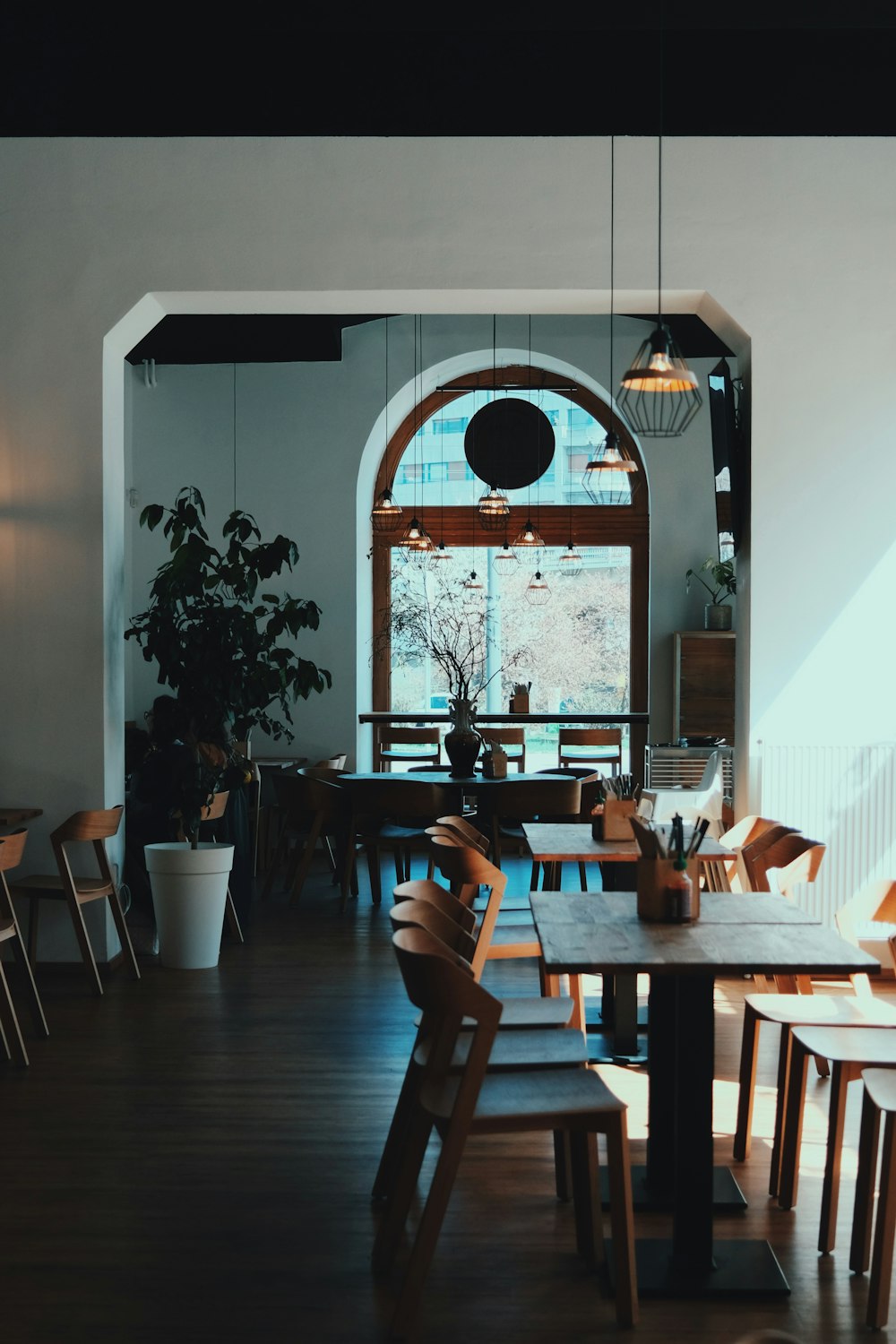 a dining room with wooden tables and chairs