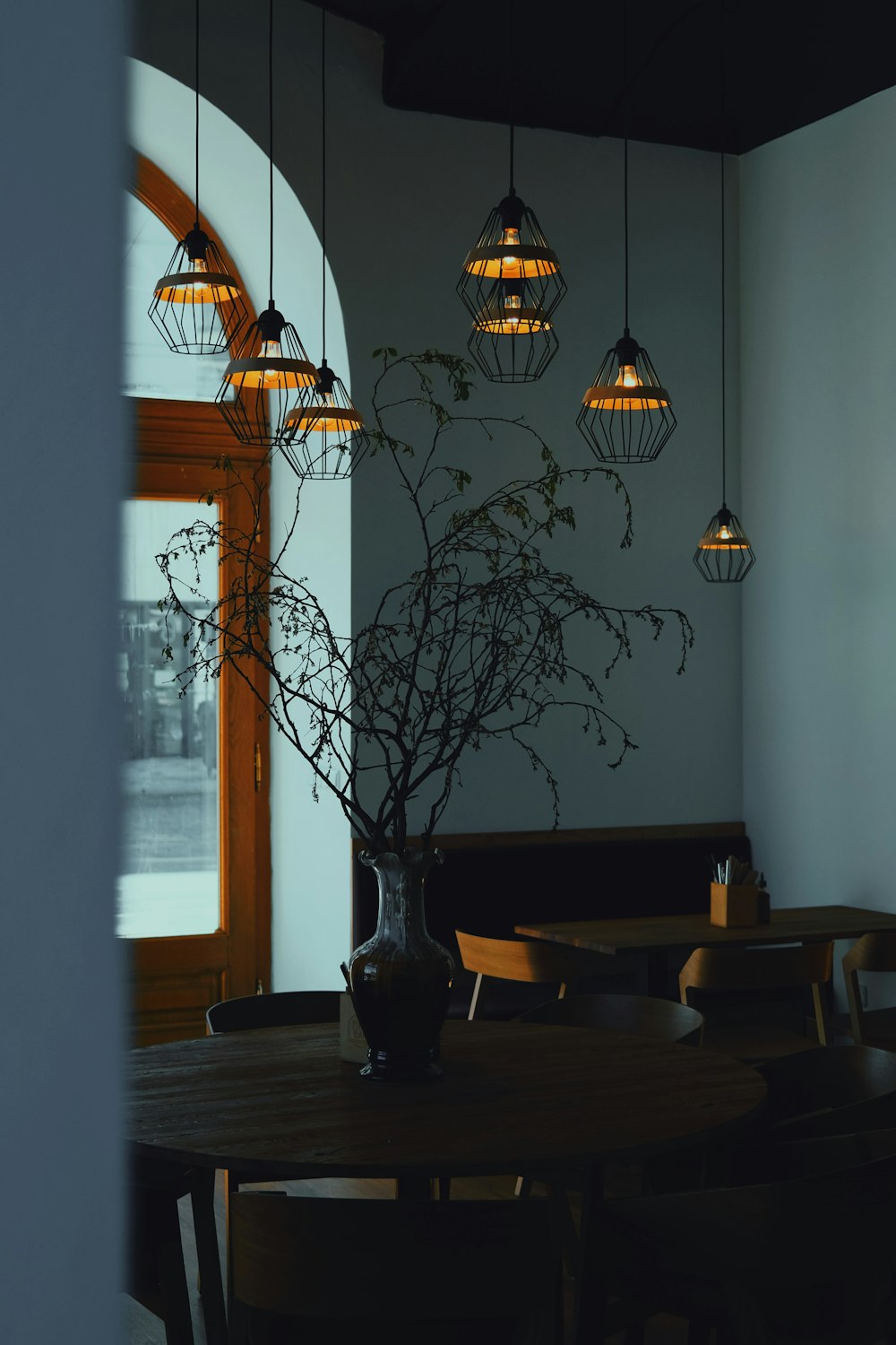 a dining room table with a vase of flowers on it