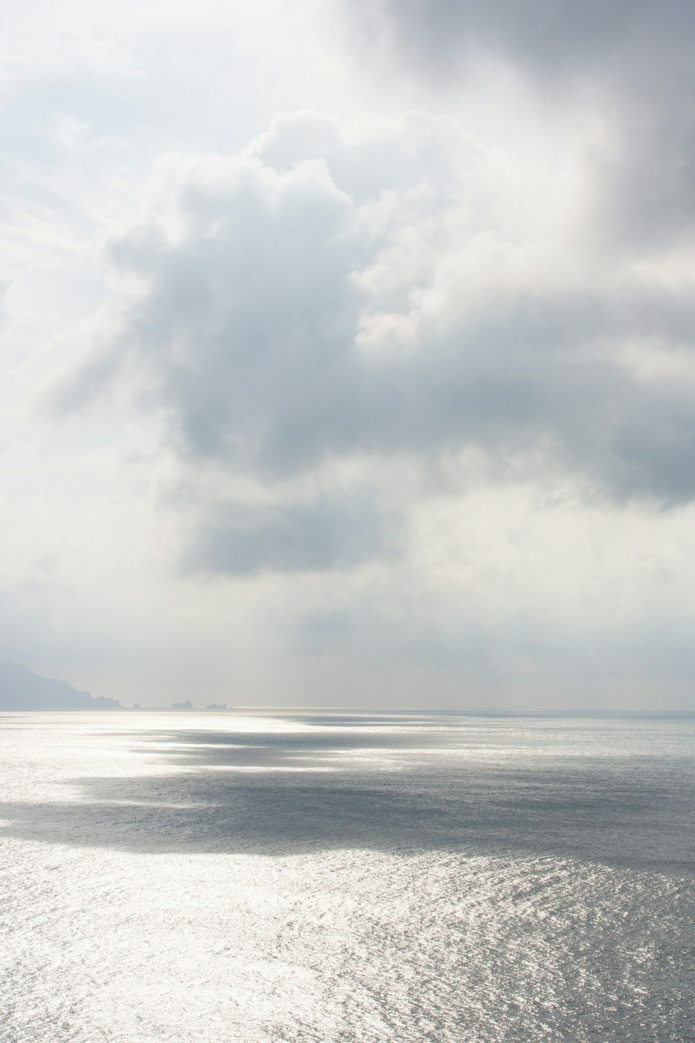 a large body of water under a cloudy sky