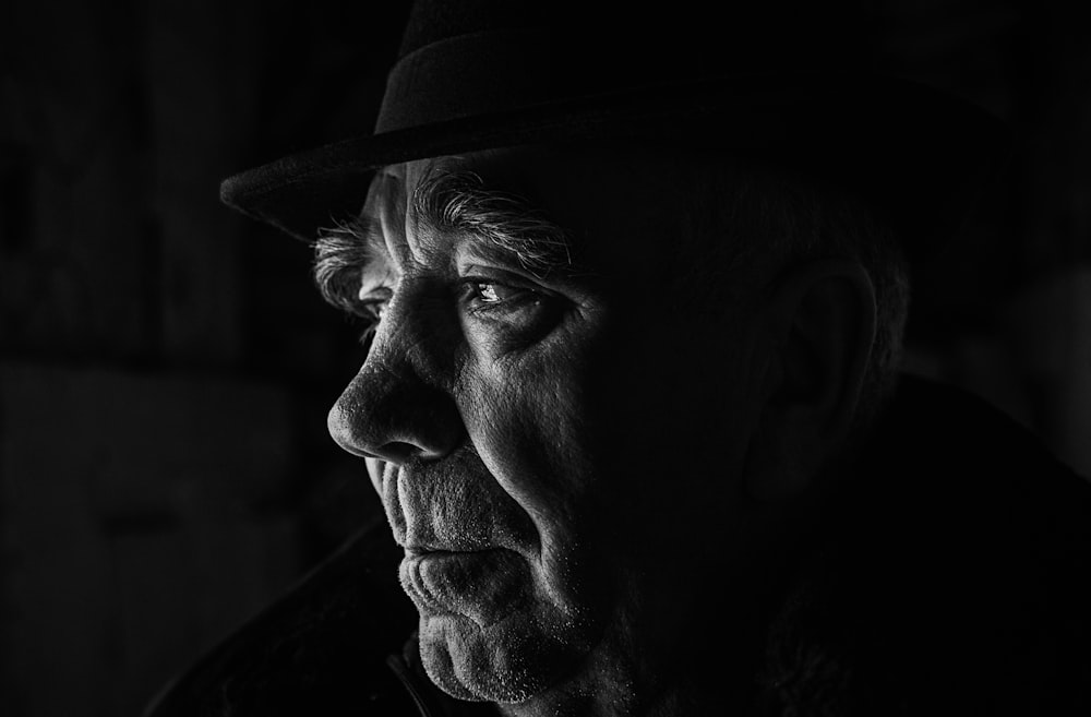 a black and white photo of a man in a hat