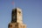 a clock tower with a flag on top of it
