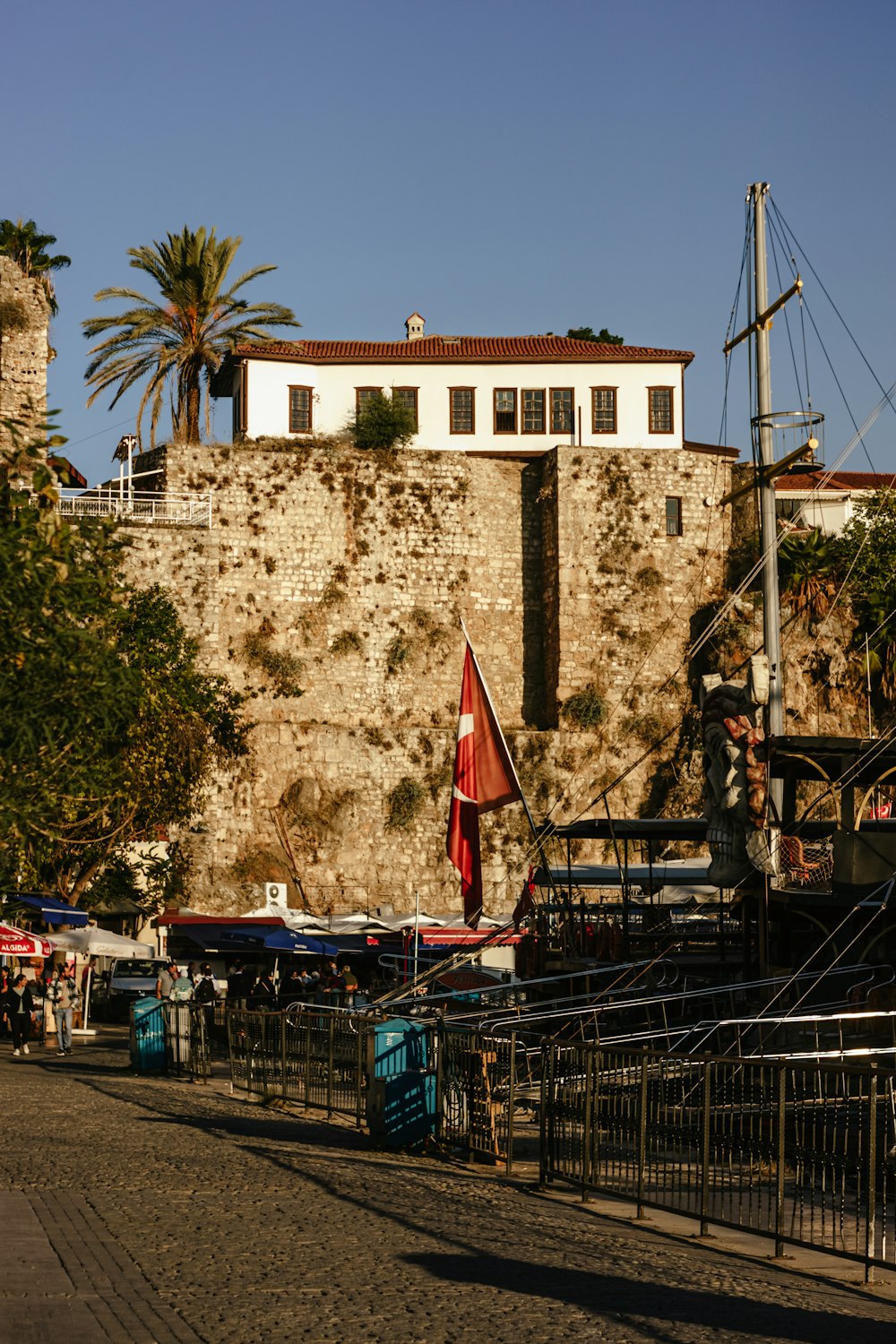 a large stone wall with a building in the background