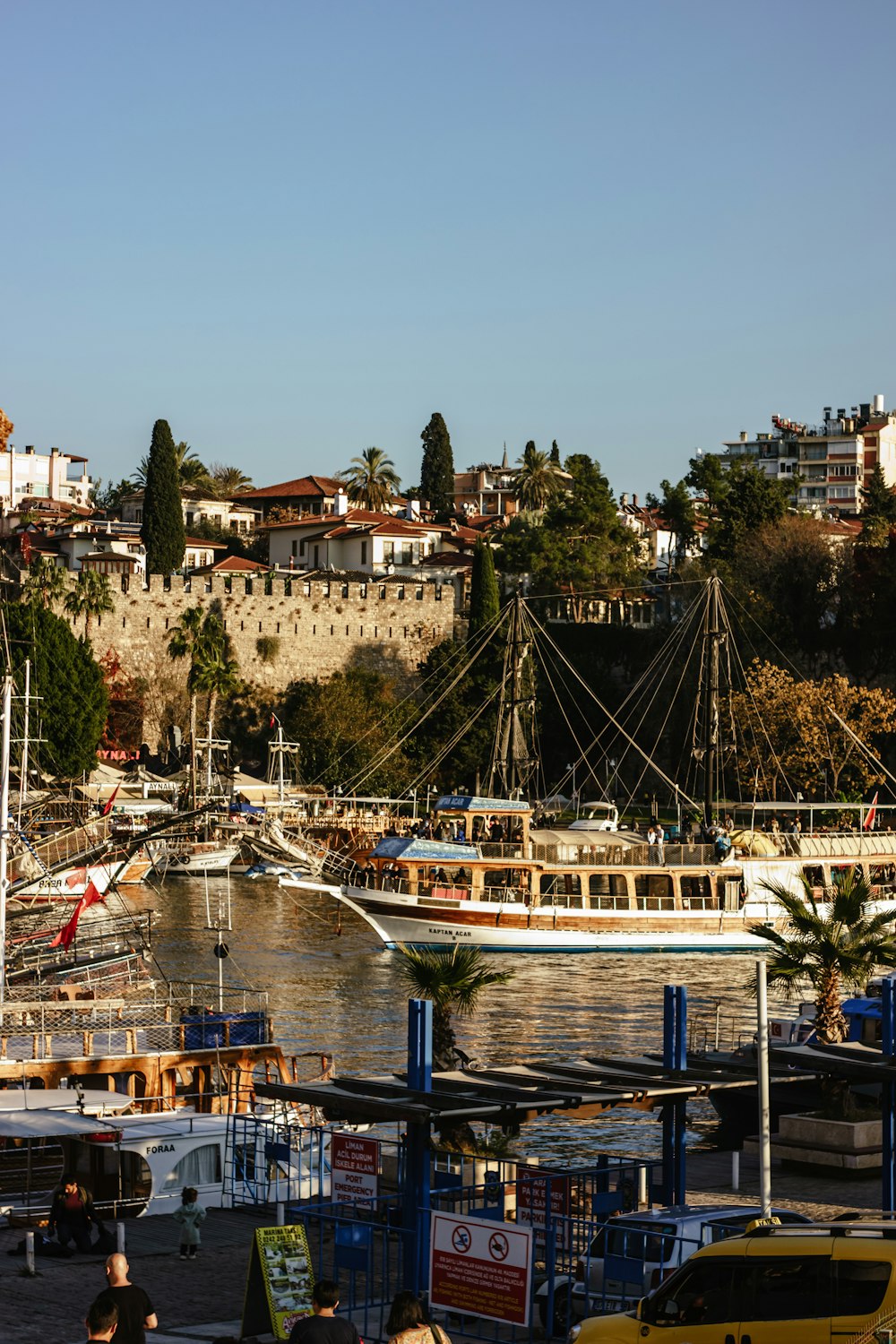 a harbor filled with lots of boats next to a city