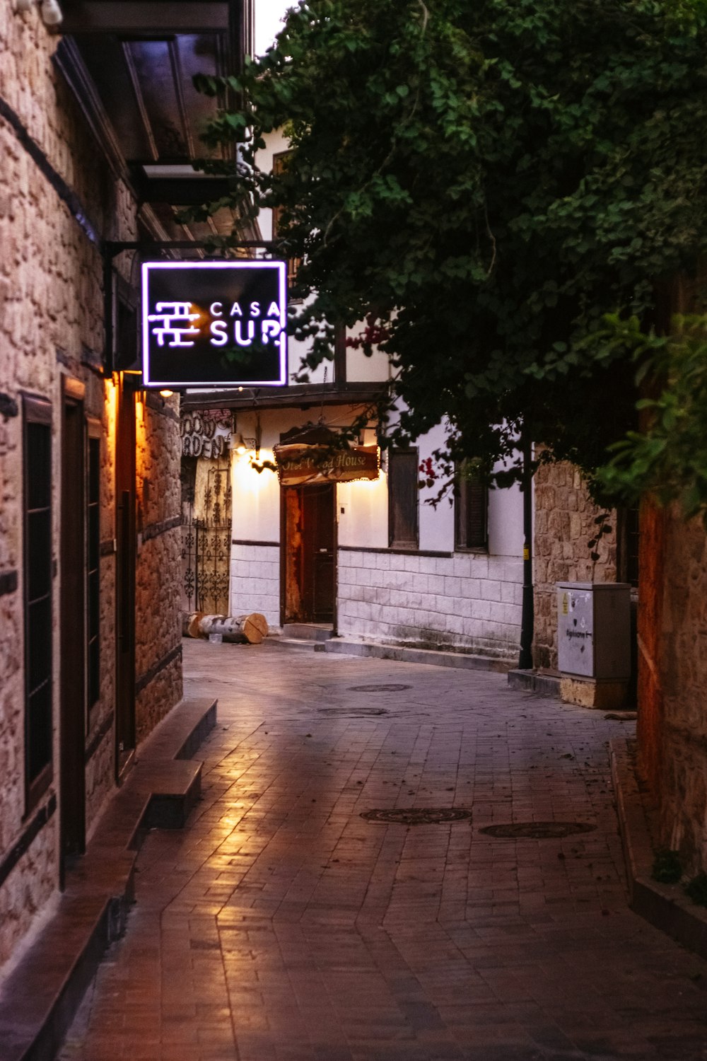 an alley way with a sign that says sushi