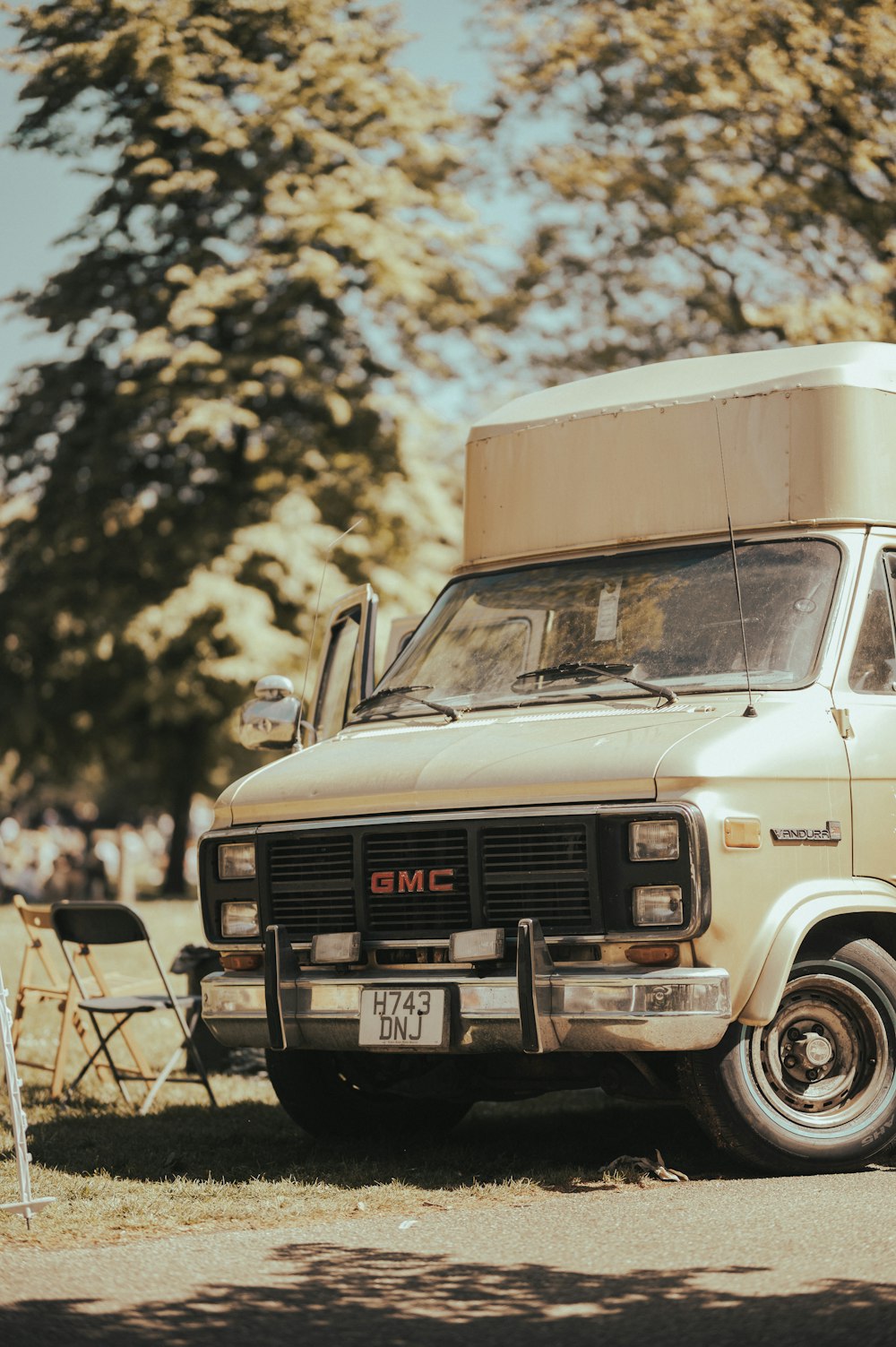 an old truck is parked in a field