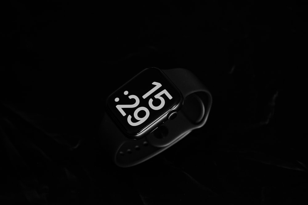 a close up of a watch face in the dark