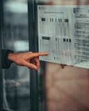 a person pointing at a poster on a wall