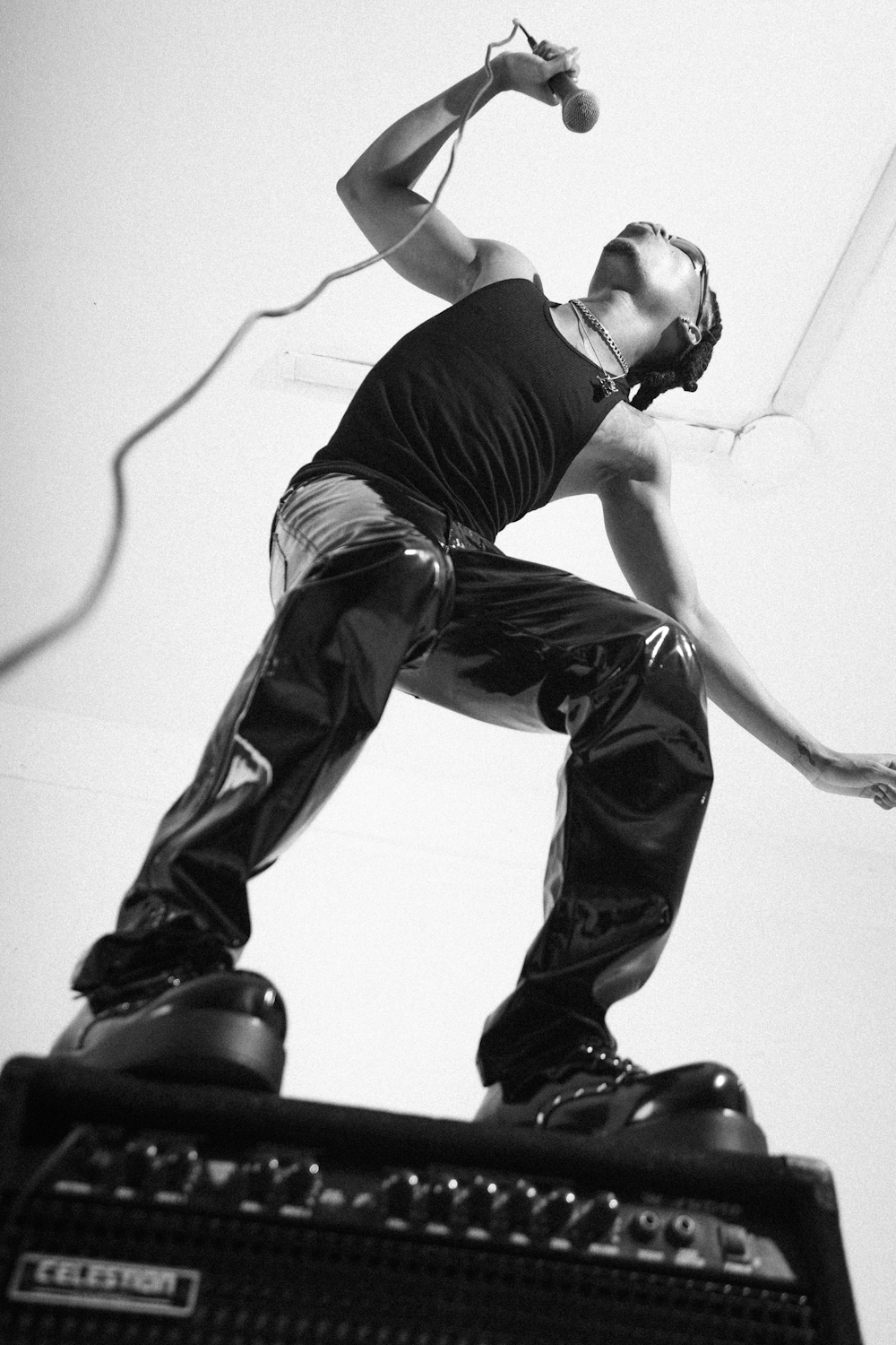 a man standing on top of a guitar amp