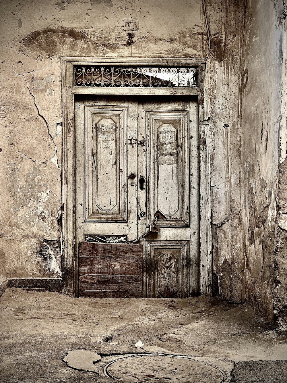 an old door with a drawer in front of it