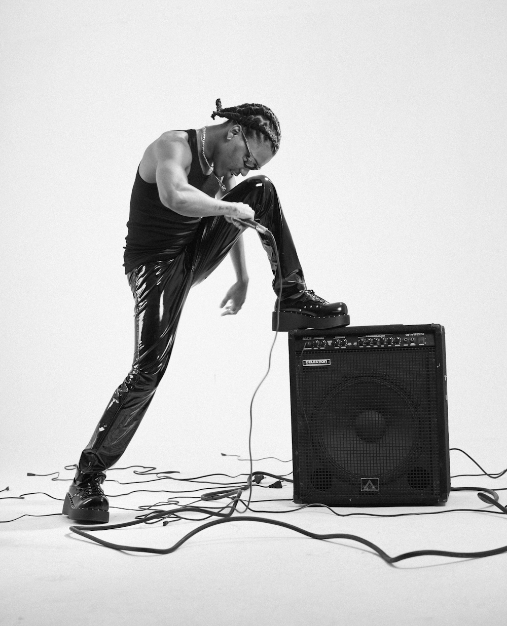 a man leaning on top of a amp