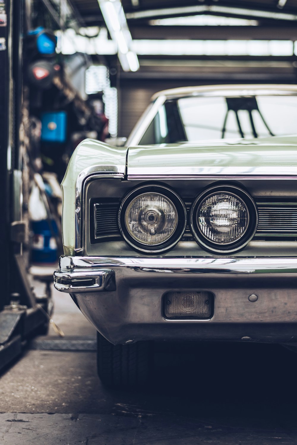 an old car is parked in a garage