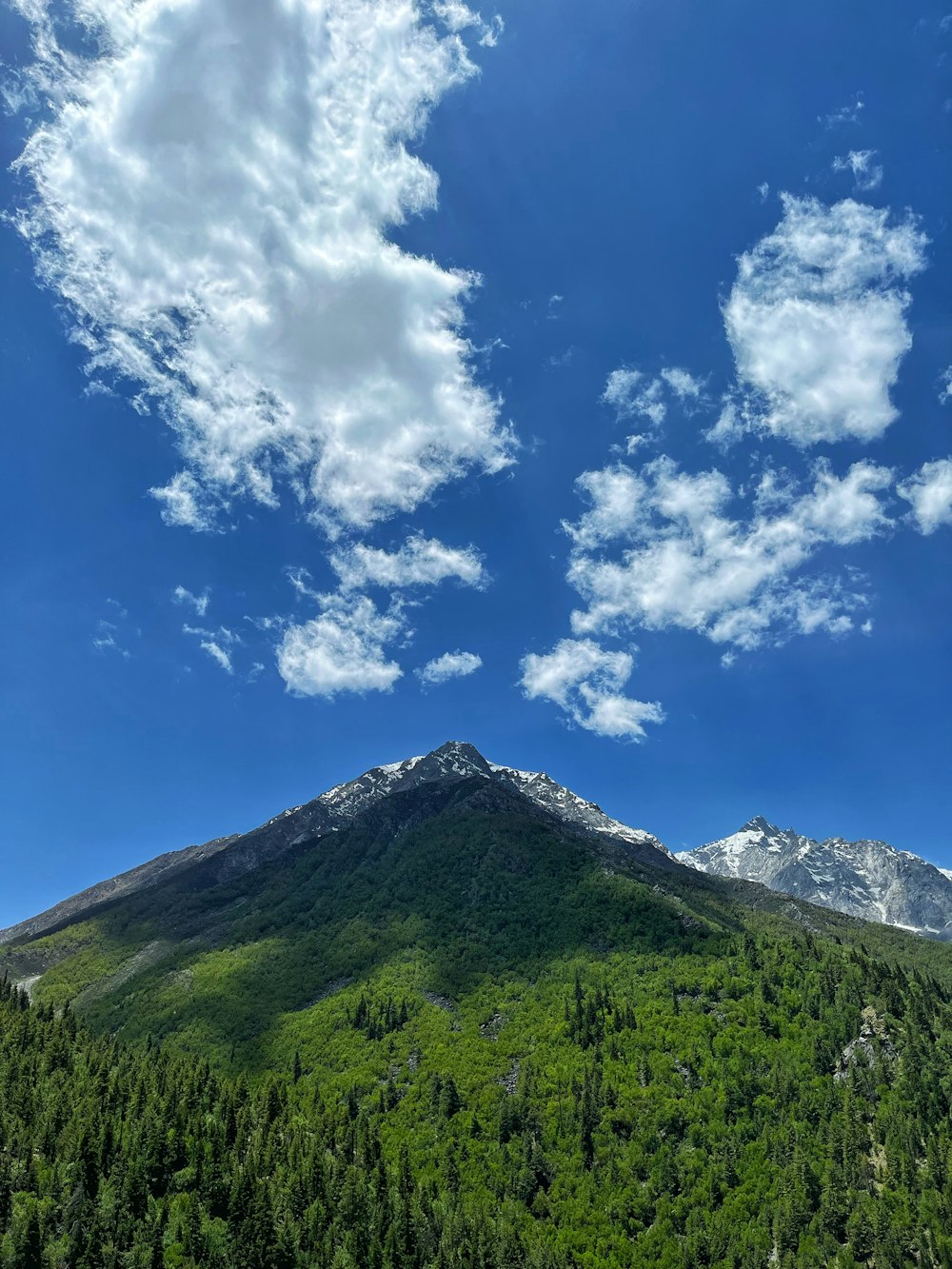 a view of a mountain with a cloud in the sky