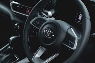 a close up of a steering wheel of a car
