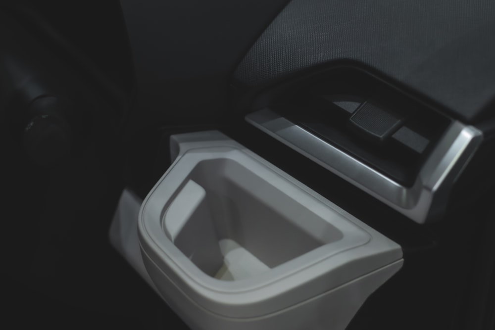 a close up of a trash can in a car