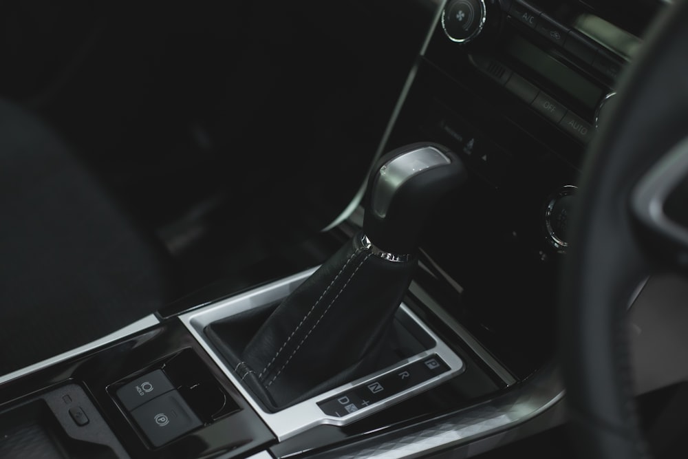 a picture of a car's gear box and dashboard