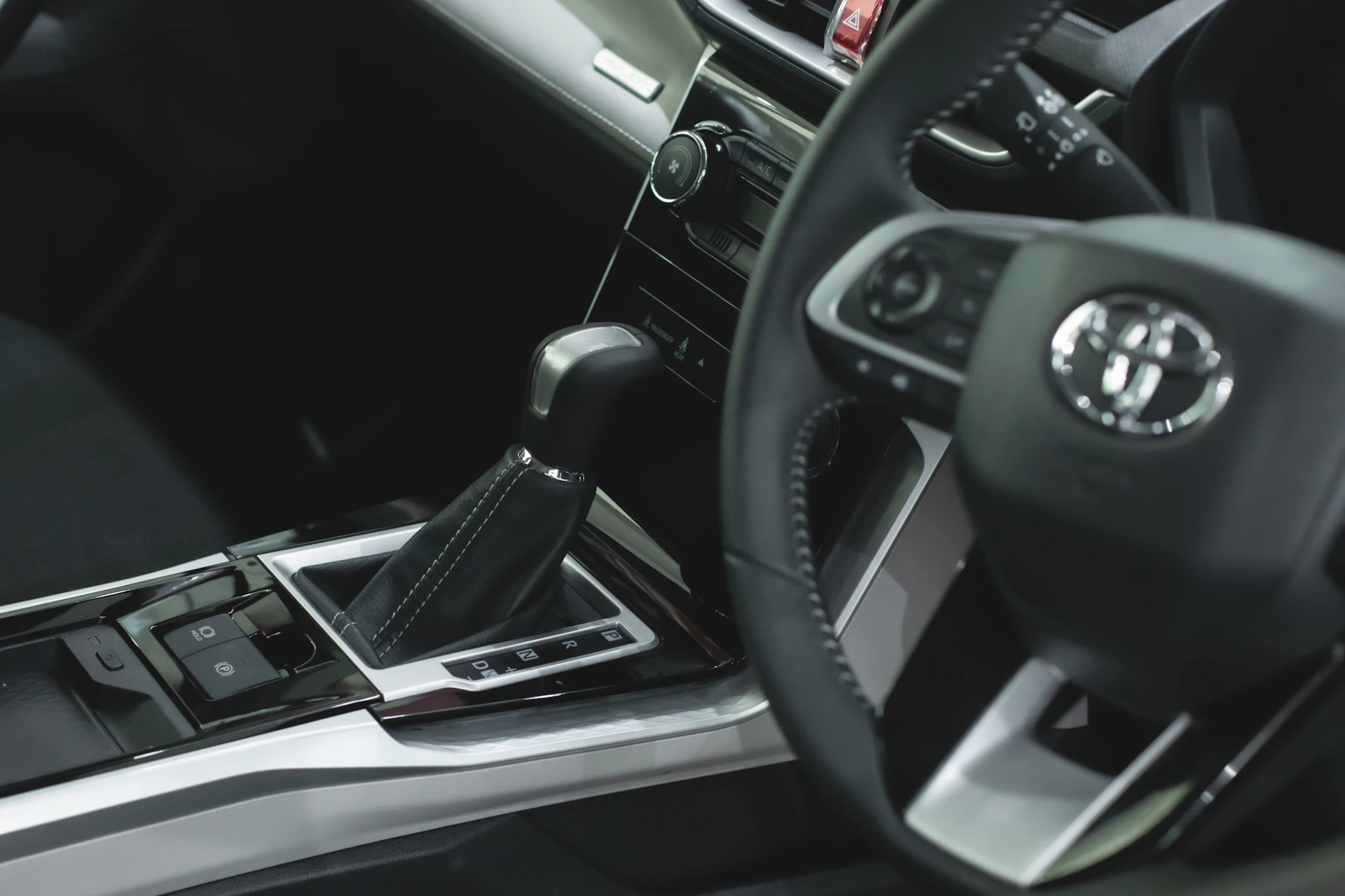 a car dashboard with a cell phone in the center