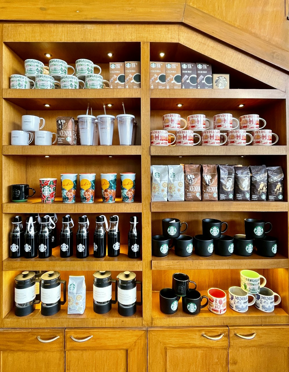 a wooden shelf filled with lots of cups and mugs