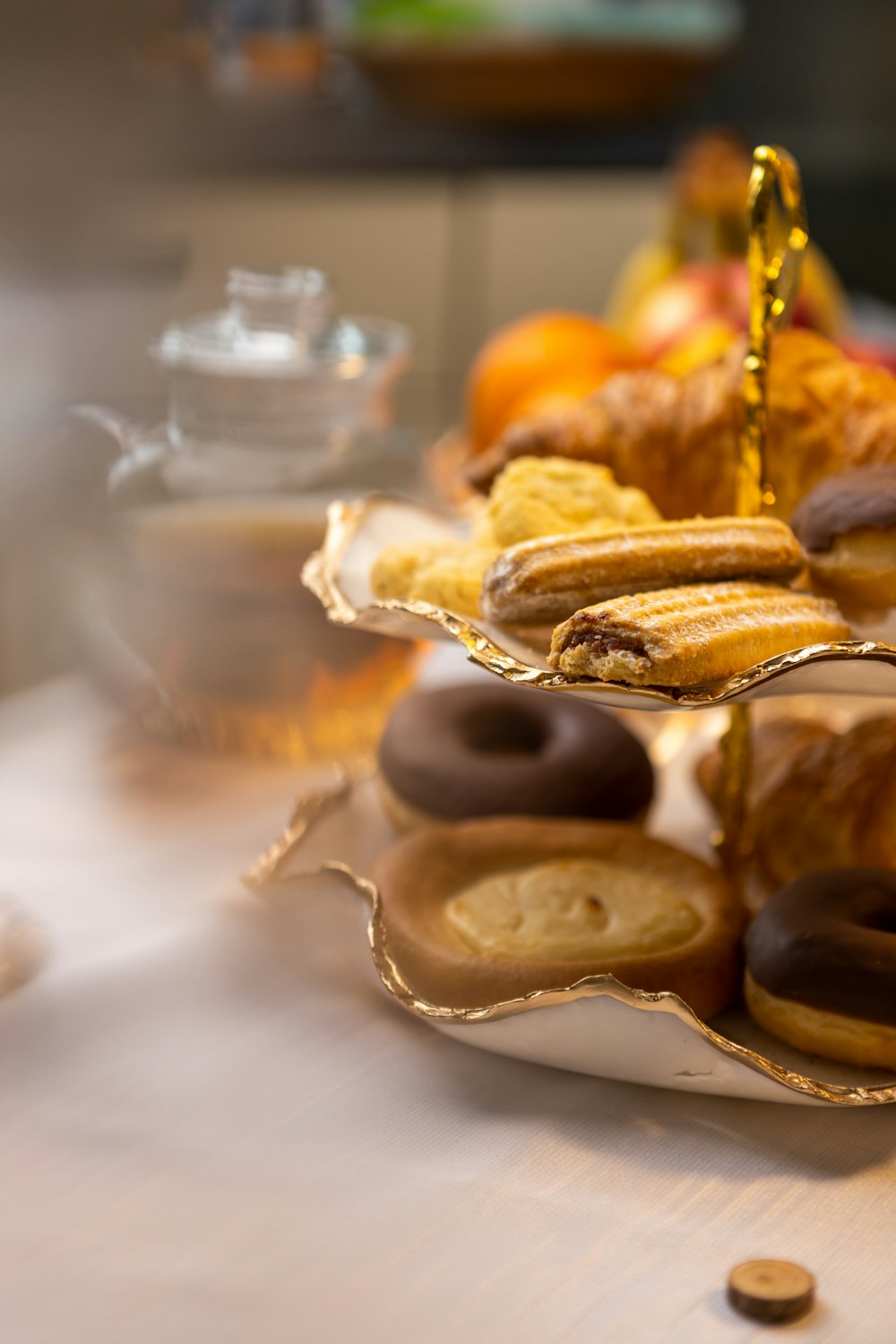 a table topped with plates of donuts and pastries