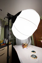 Behind-the-scenes moment of a photographer capturing product shots with soft, diffused lighting.