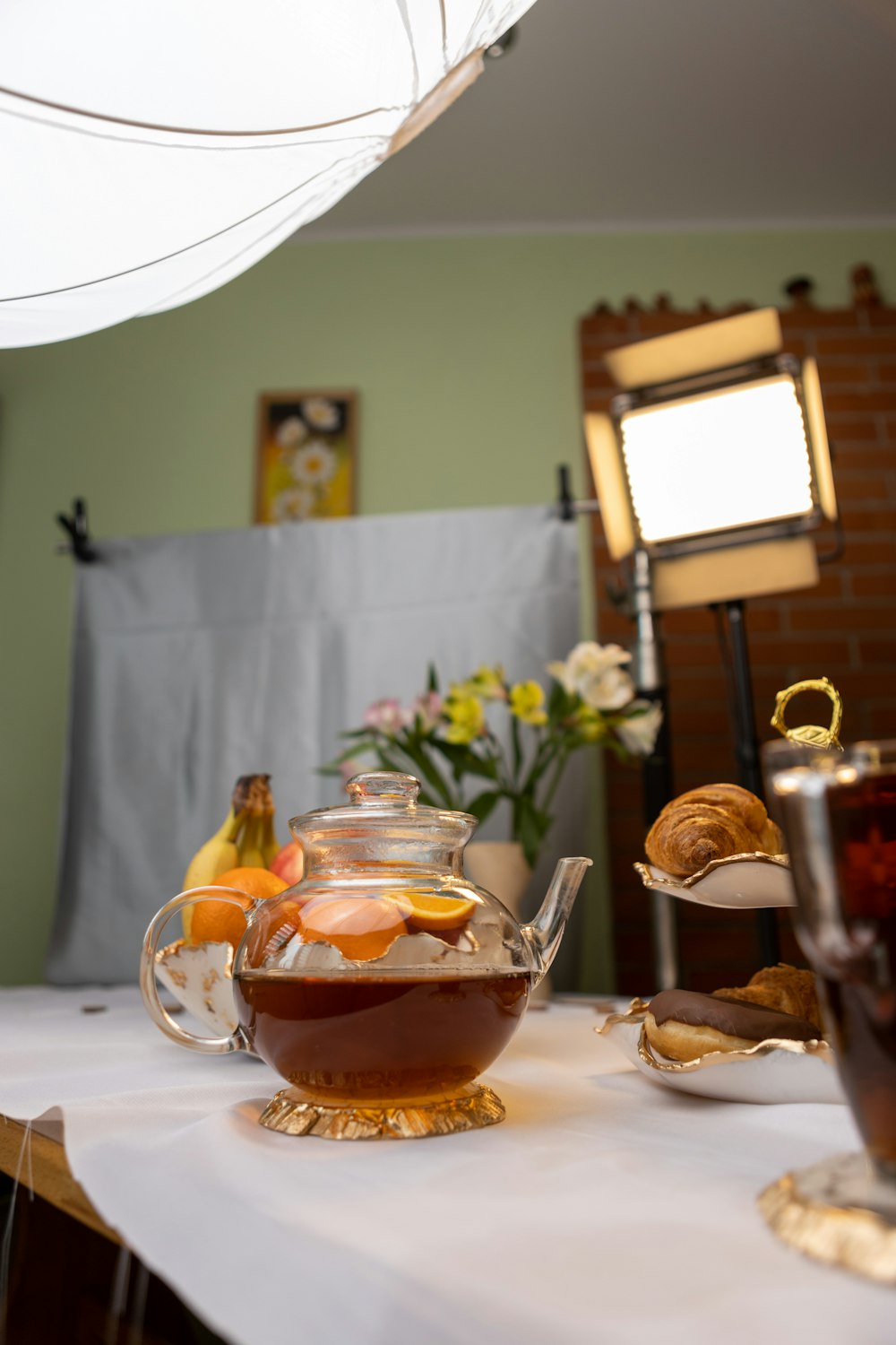 a tea pot filled with fruit and tea on top of a table