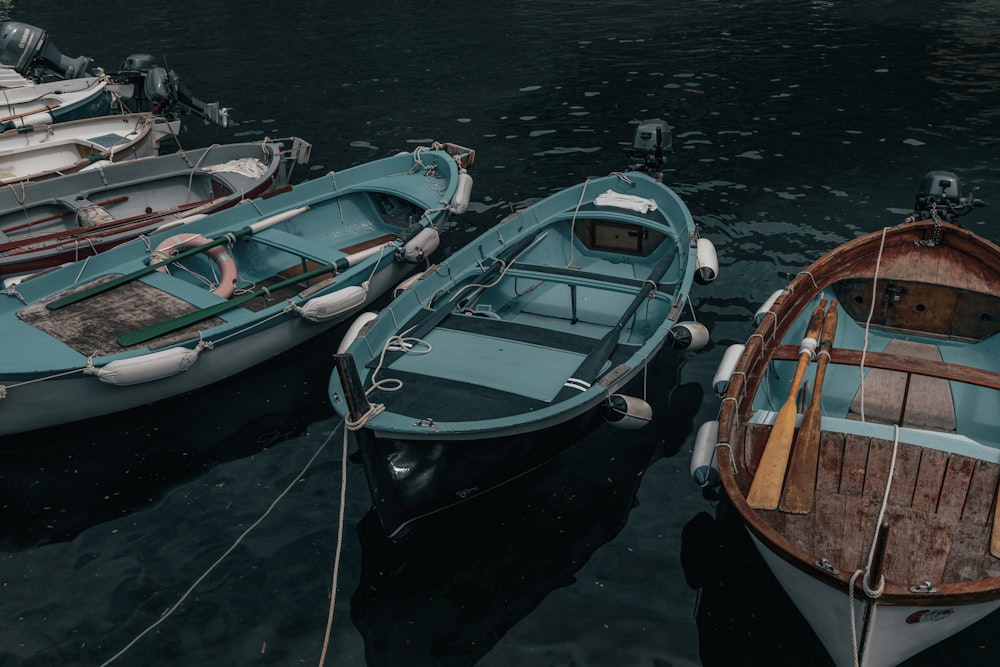 a group of small boats tied to a dock