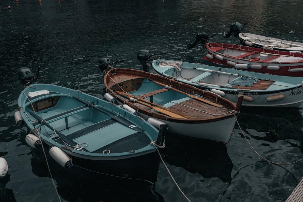 a group of small boats tied to a dock