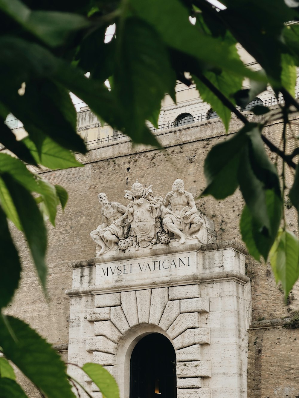 the entrance to a building with statues on it