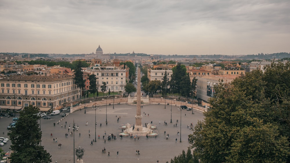 a view of a square with a fountain in the middle