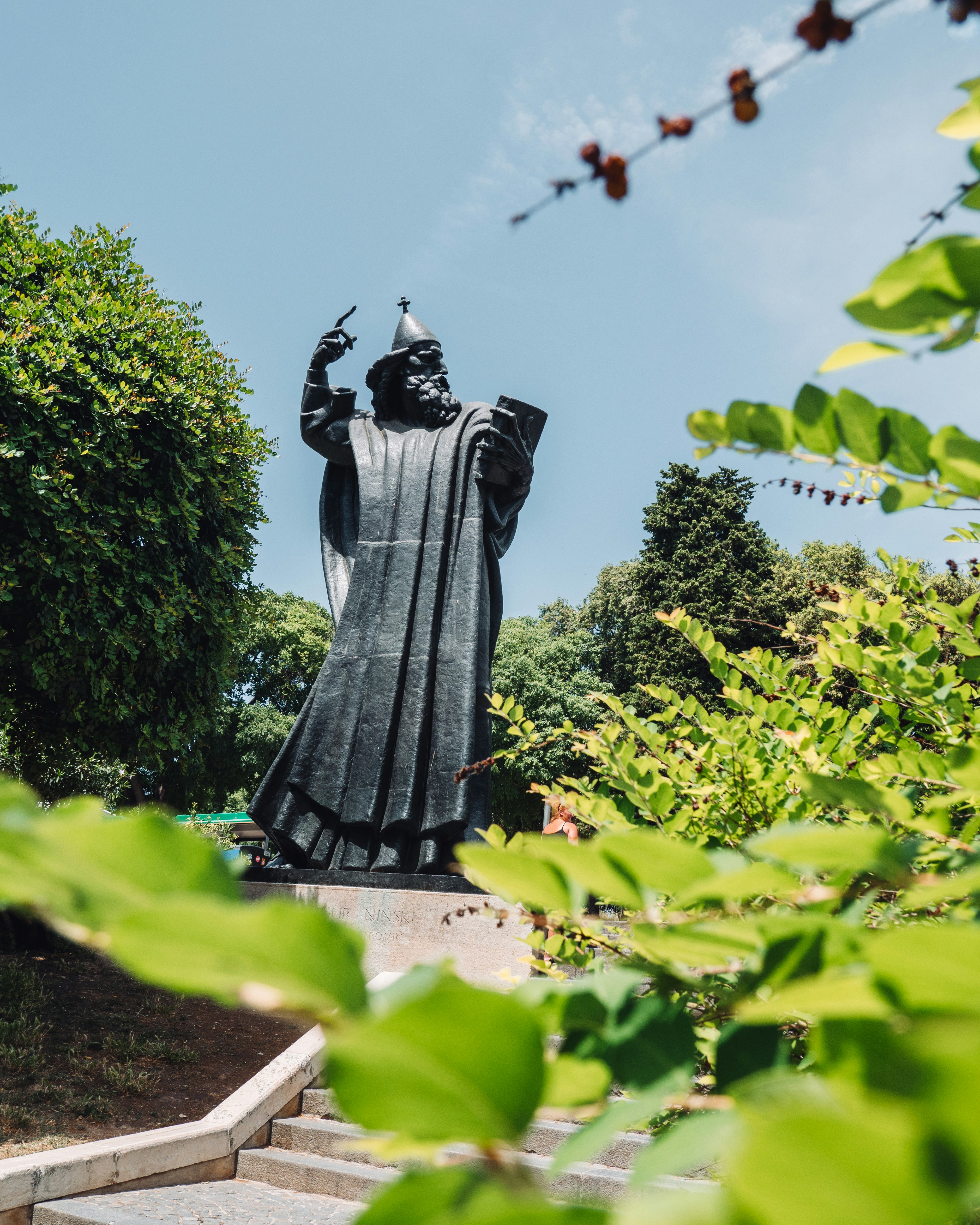 a statue of a man holding a pipe in his hand
