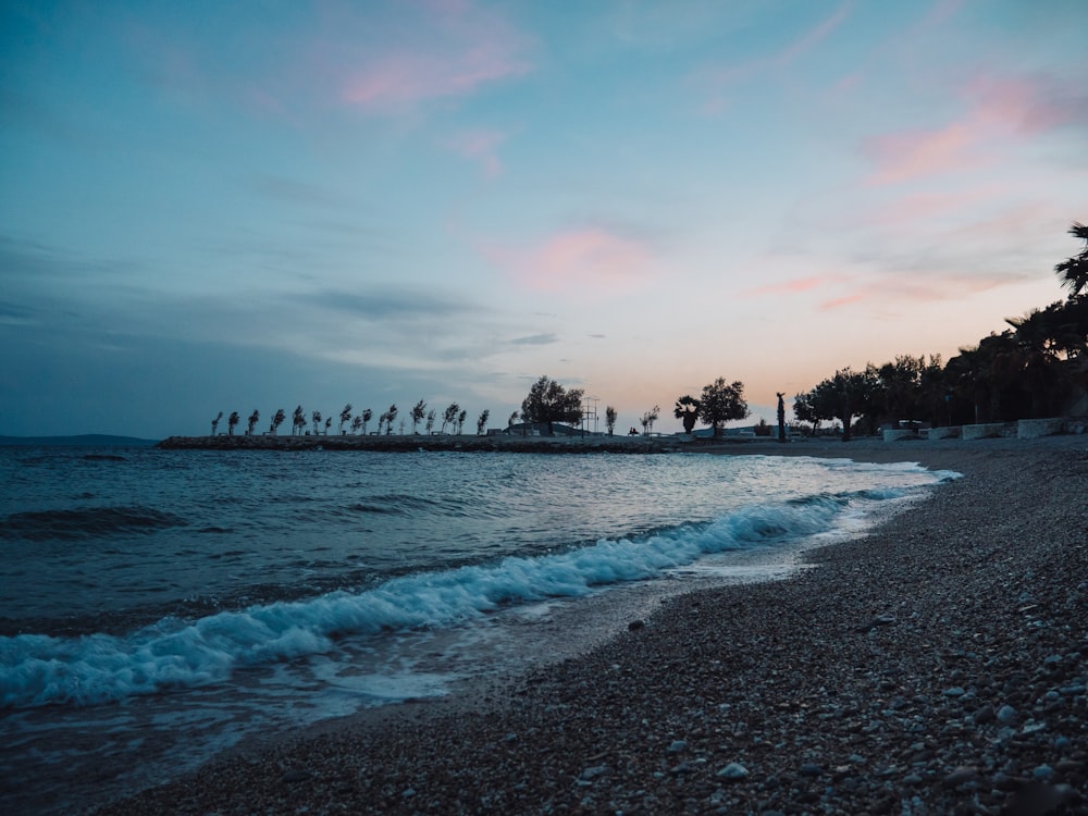 a beach with waves coming in to the shore