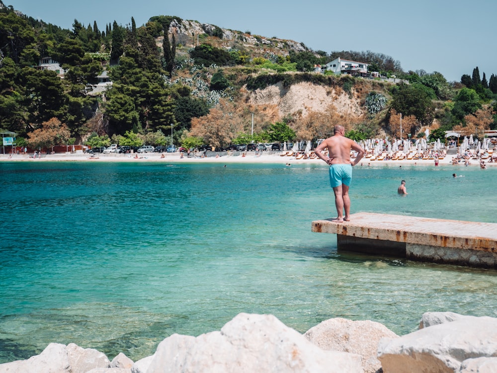 a man standing on a dock in the water