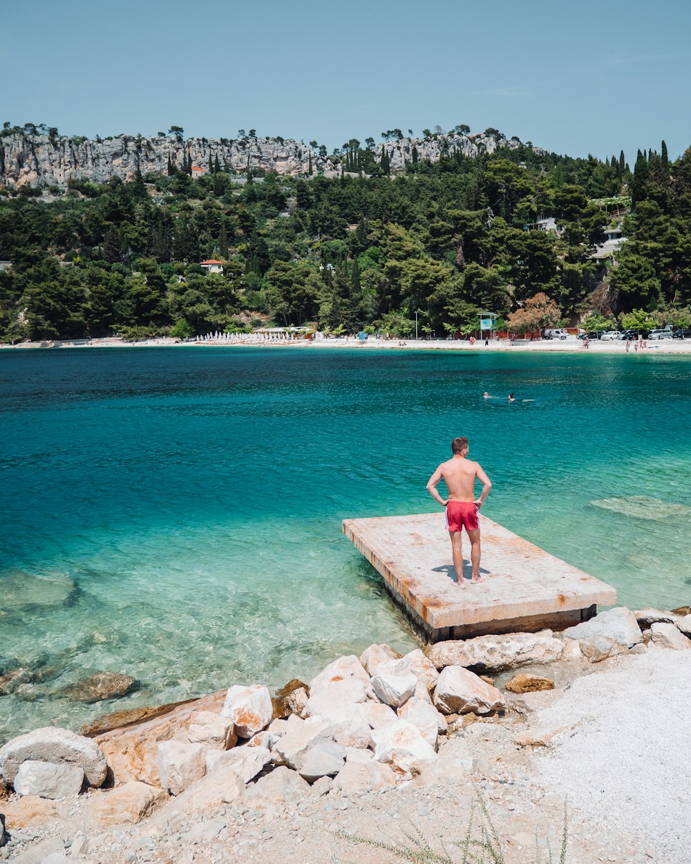 a man standing on a dock in the water