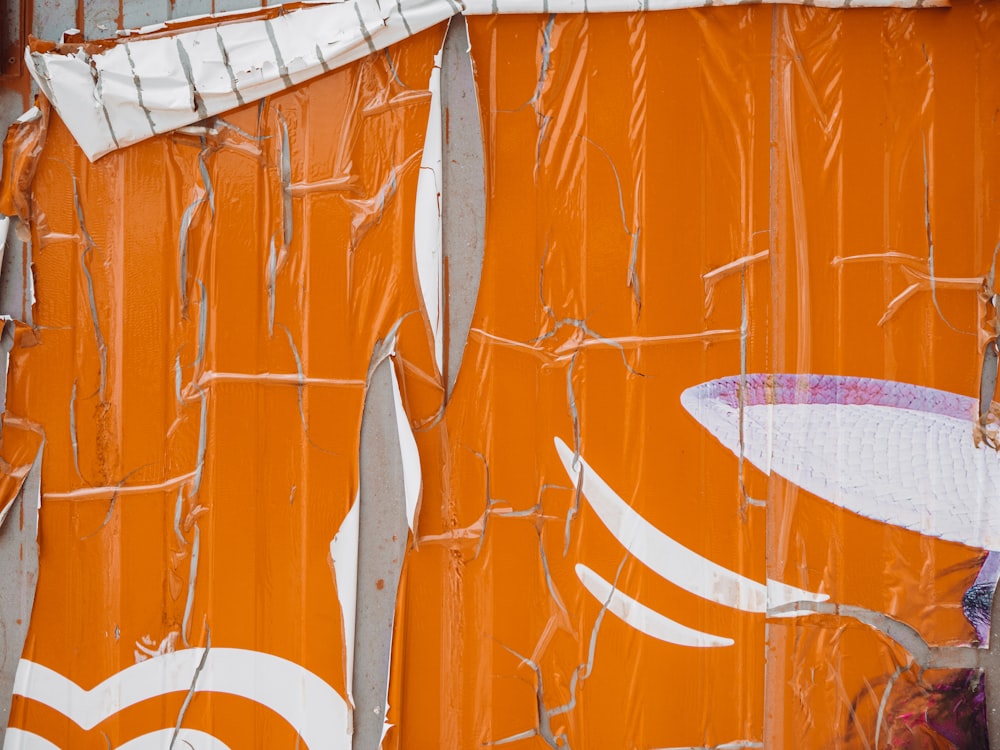 an orange wall with a surfboard on top of it