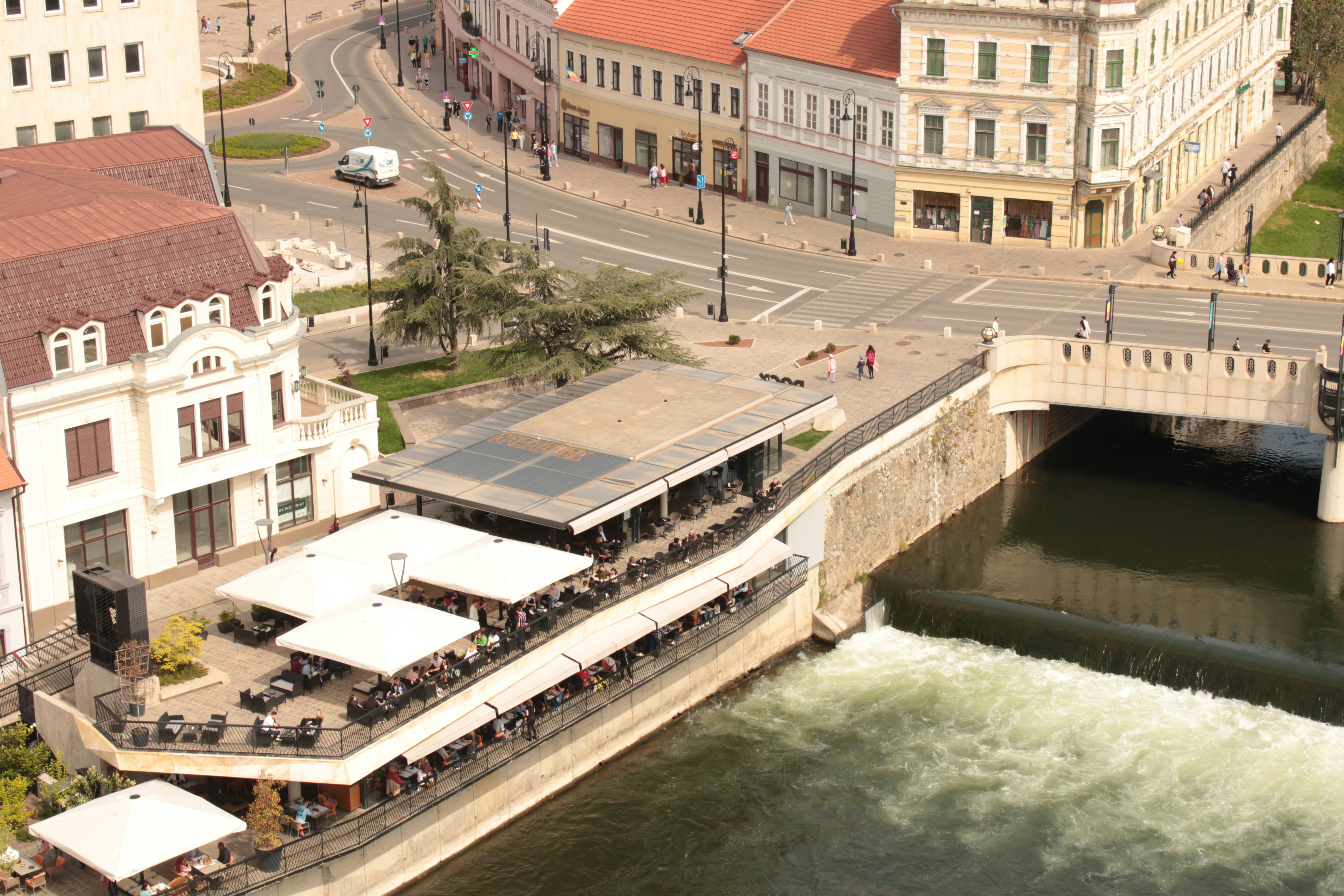 a river running through a city next to tall buildings