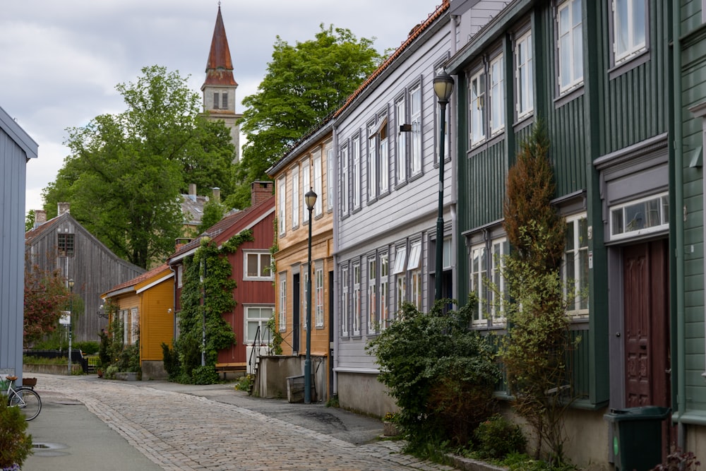 a cobblestone street lined with colorful houses