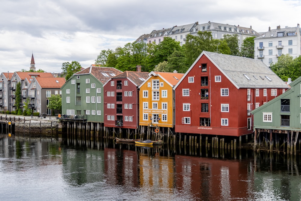 a row of houses sitting next to a body of water