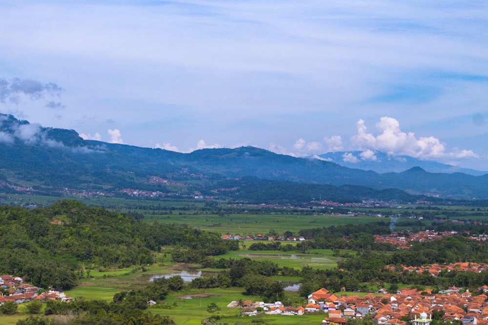 a scenic view of a small town in the mountains