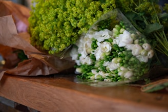 Close-up of a beautifully wrapped flower basket with ribbons and a greeting card.