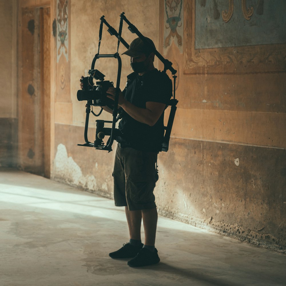 a man holding a camera in a room