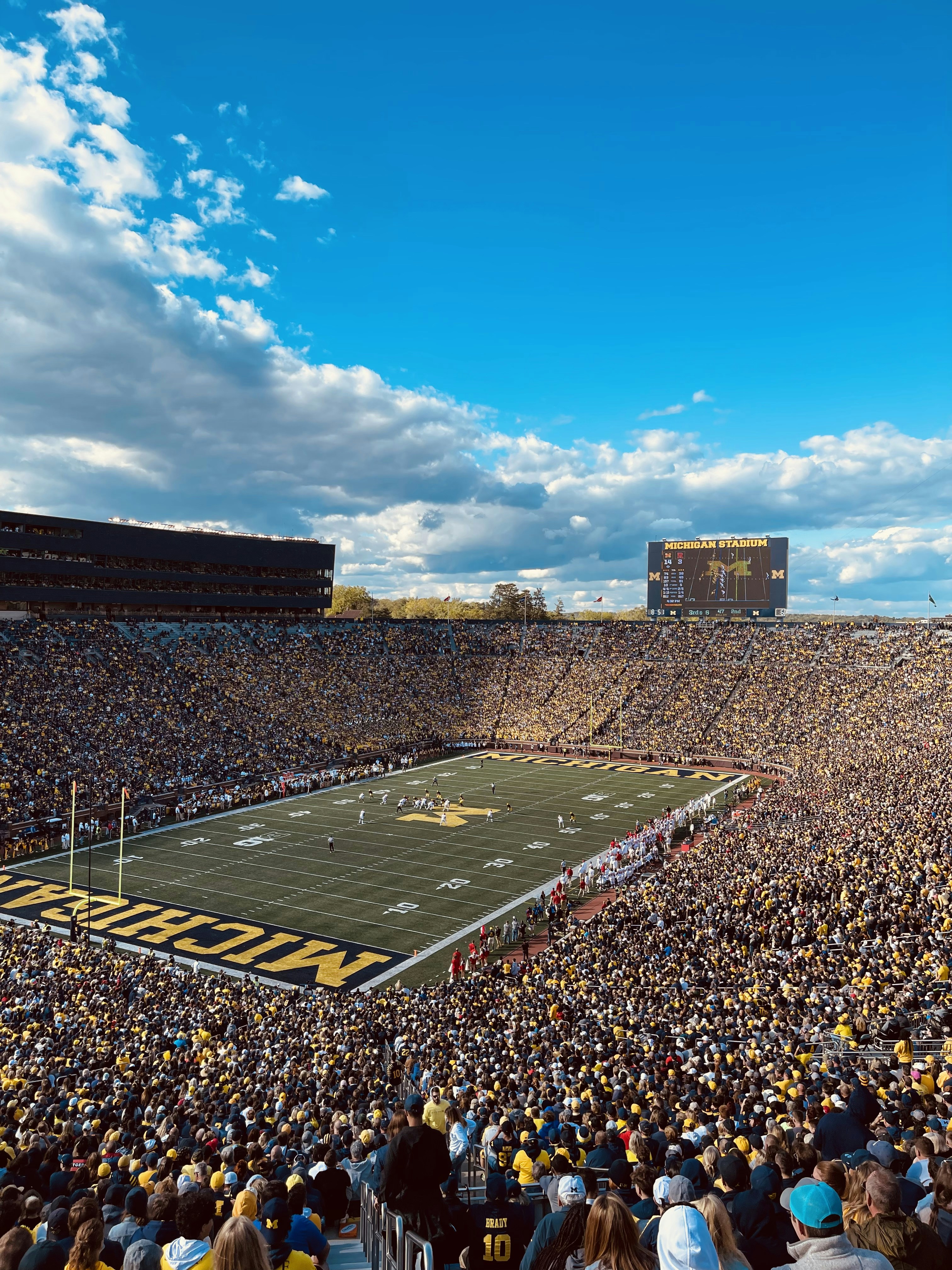 a football stadium full of fans and a football field
